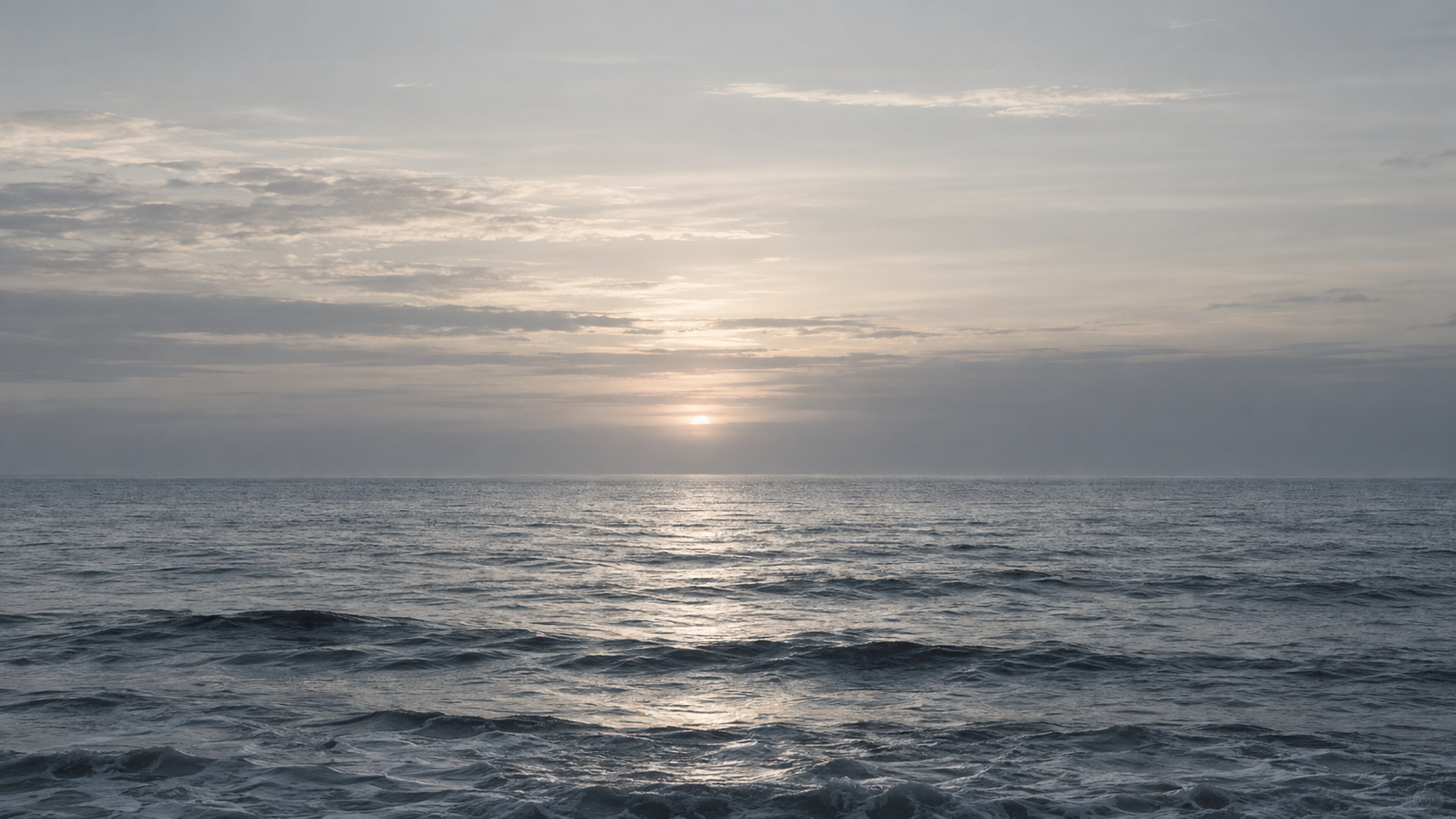 Silver-grey sea beneath a cloudy horizon.